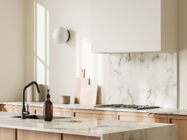 White marble kitchen island with matching splashback and wooden cabinetry.