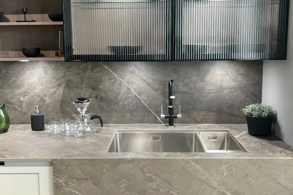 Marble kitchen countertop with glass cabinets. 