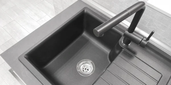 A composite sink with matching tap and integrated drainage board.
