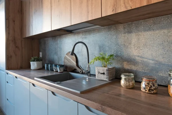 A top-mounted kitchen sink fitted to a wooden worktop.