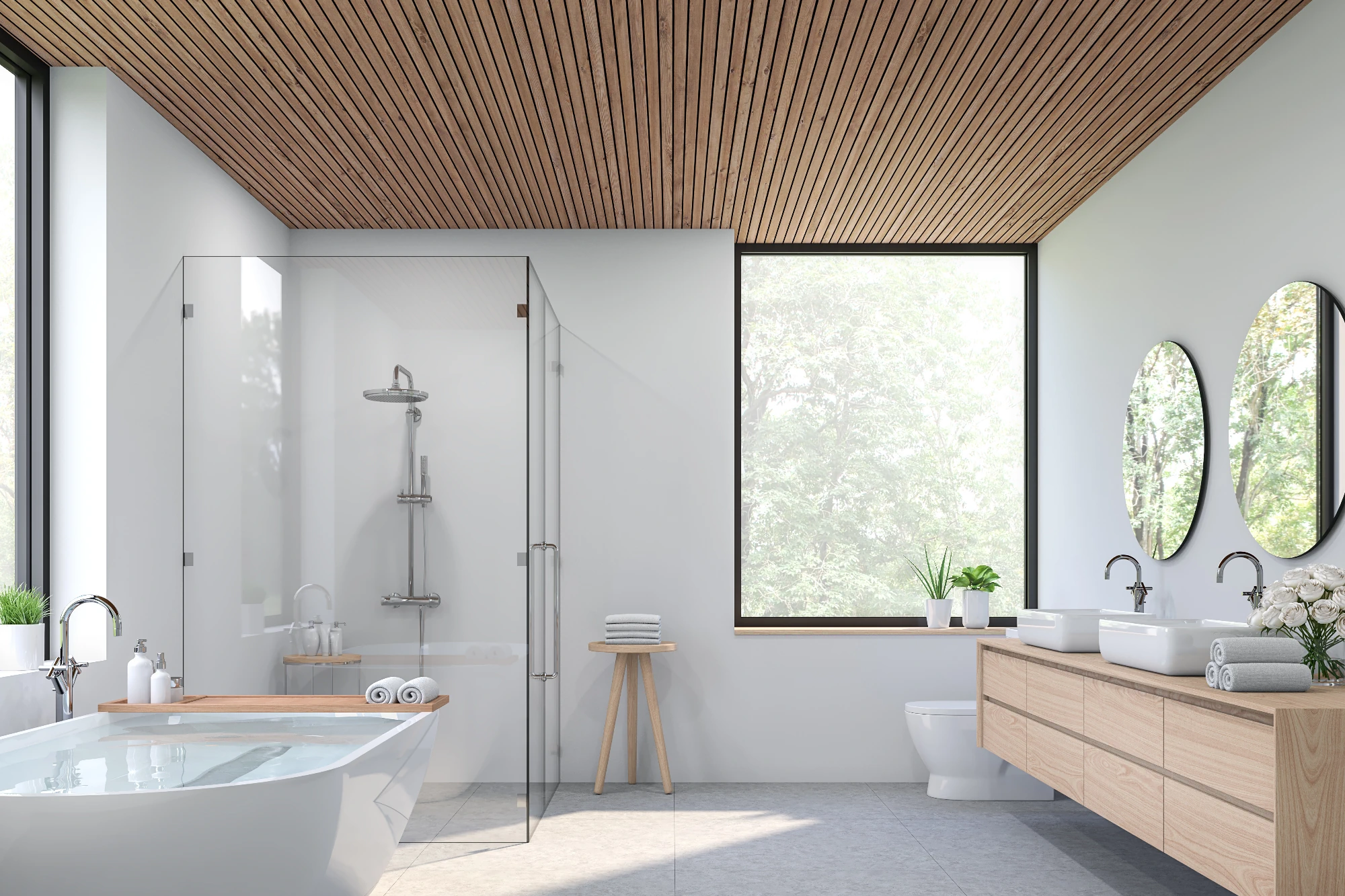 A minimalist bathroom with a vaulted slatted wood ceiling, a large window overlooking a forest, a freestanding bathtub, and a light wood double vanity with two oval mirrors. 