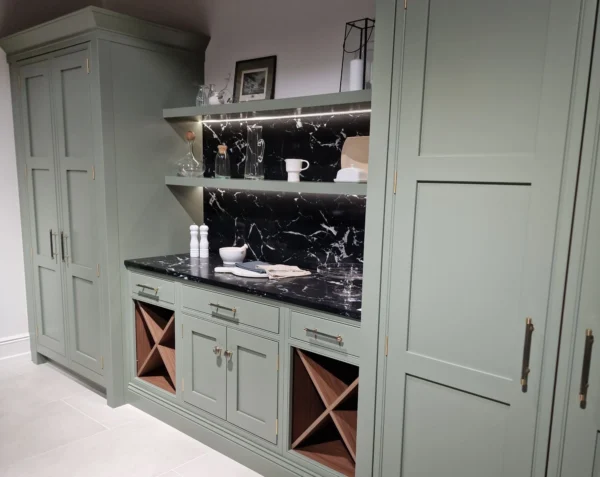 A large kitchen storage area featuring in frame units in a duck egg colour.