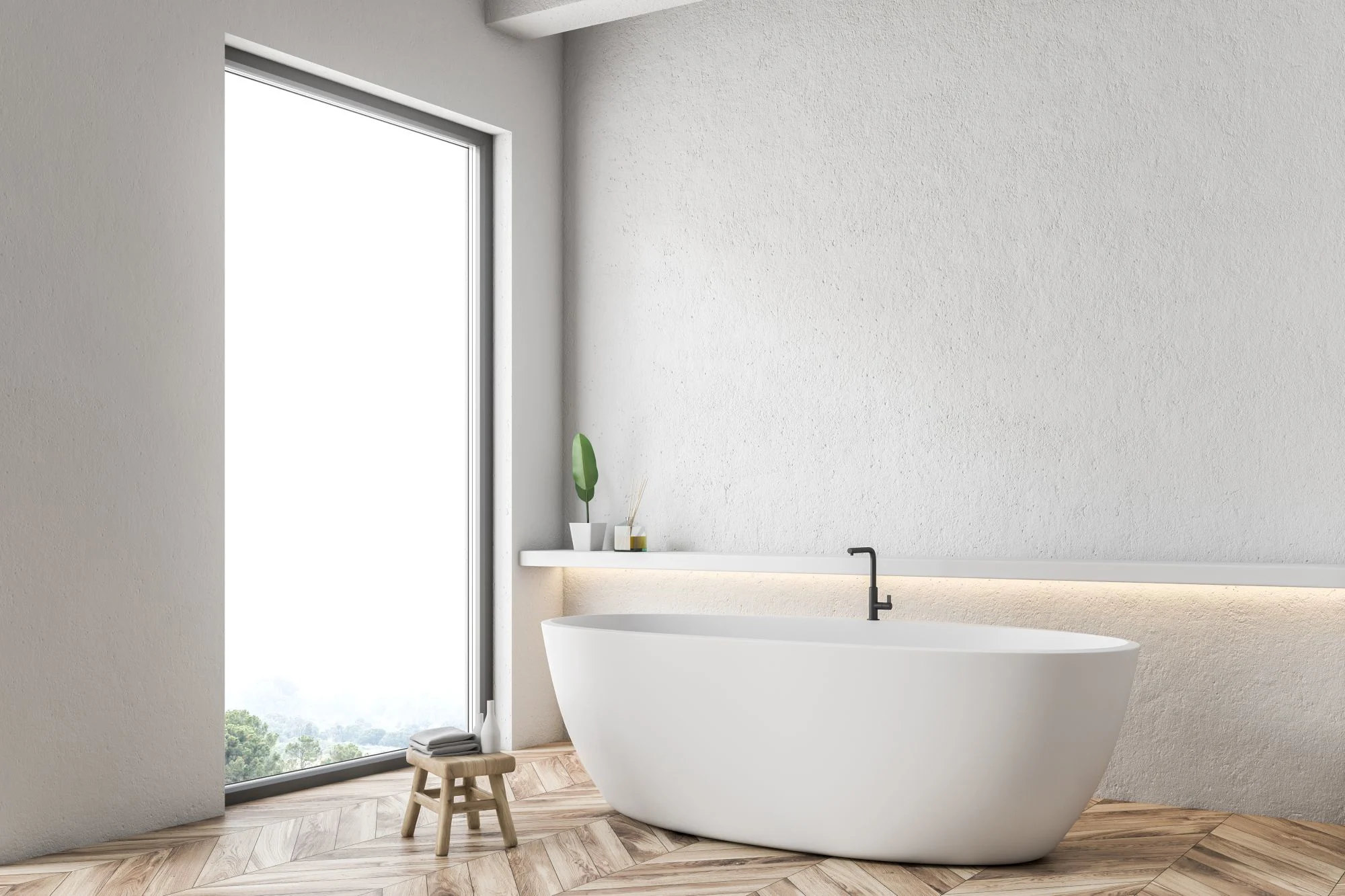 Modern white bathroom with a large window, oval freestanding tub, light textured walls, and a herringbone wood floor.