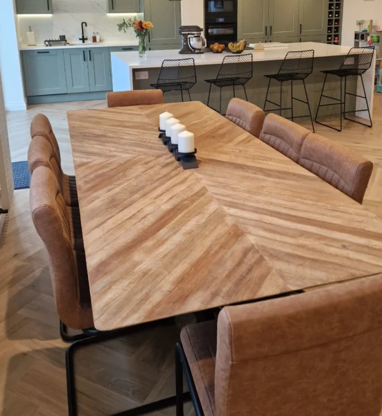 Brown, wooden table with eight brown leather chairs.