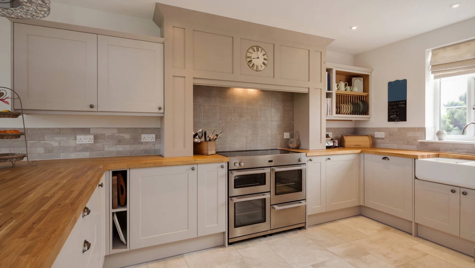 A spacious shaker kitchen with neutral cabinetry and wooden countertops.